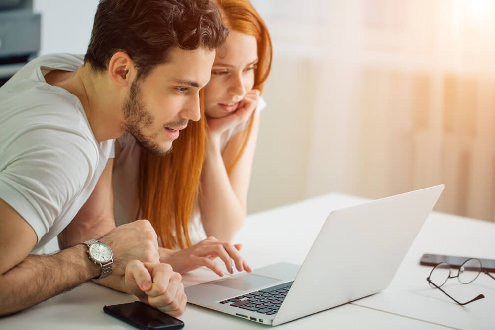 couple looking at installment loan terminology on laptop