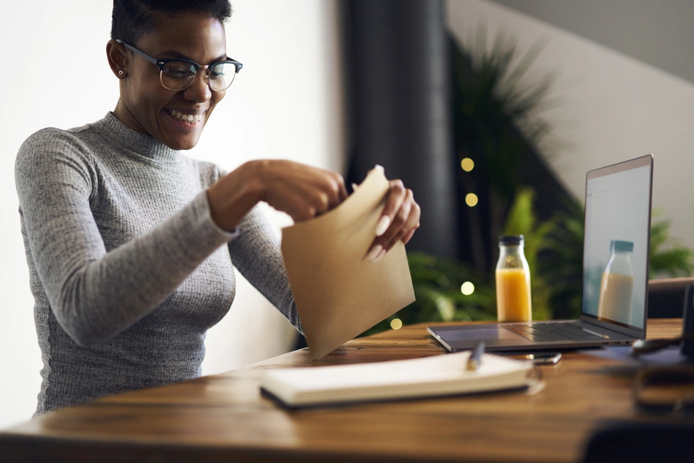 woman putting a letter into an envelope