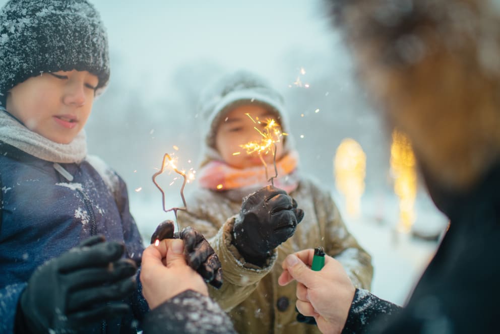 friends with sparklers in the snow