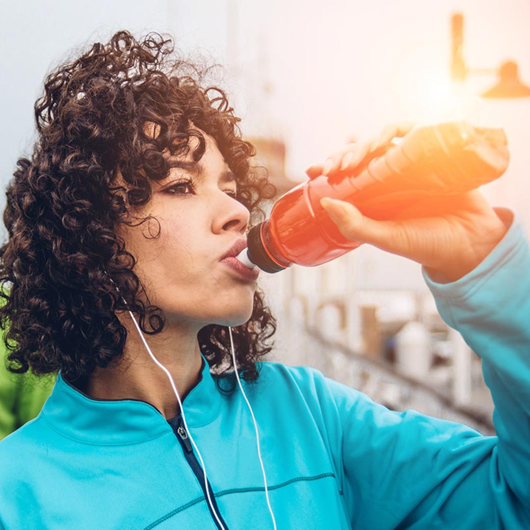 Woman drinking from water bottle