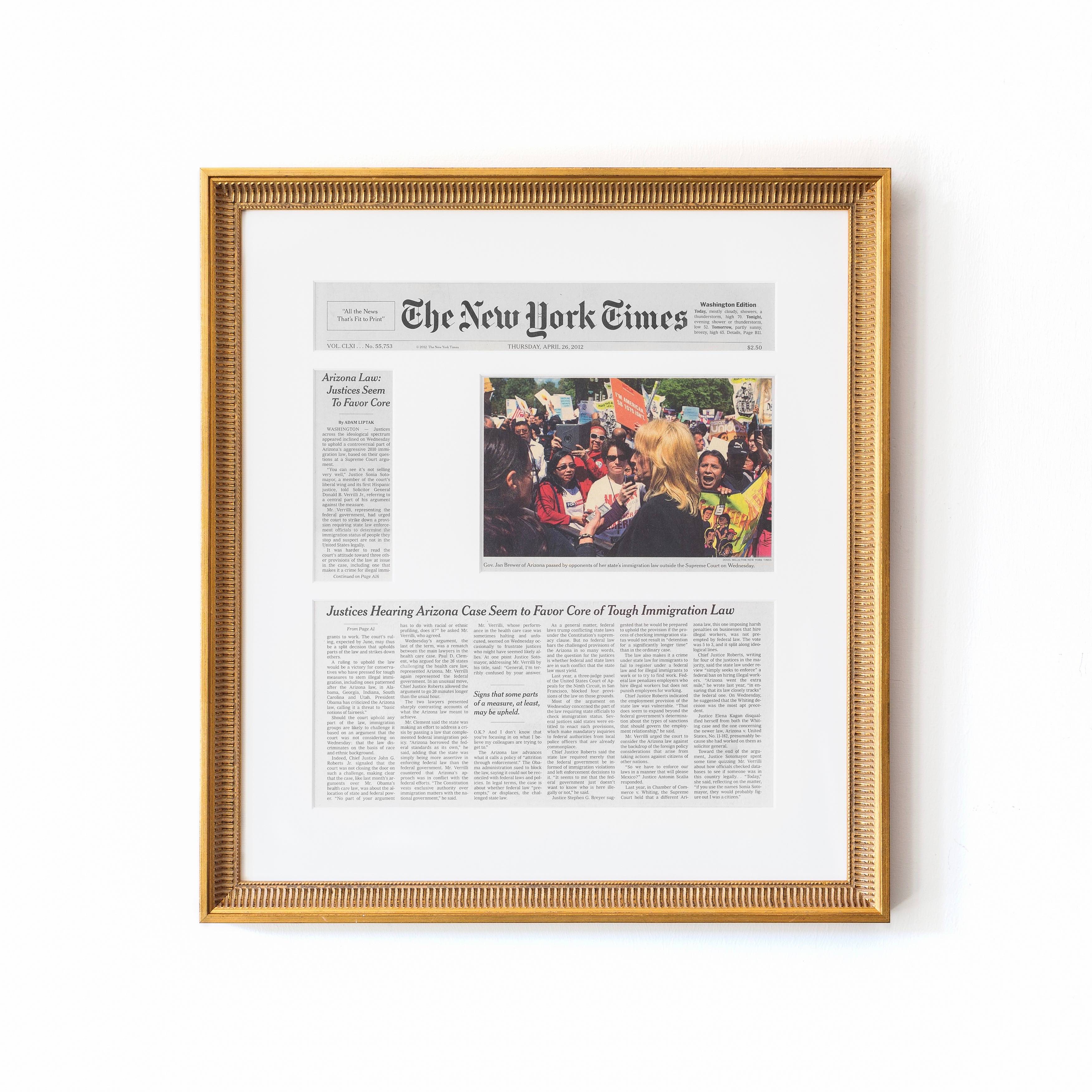 newspaper article in gold frame