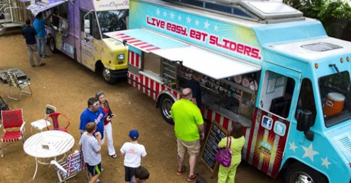 People ordering from a food truck as seen from above
