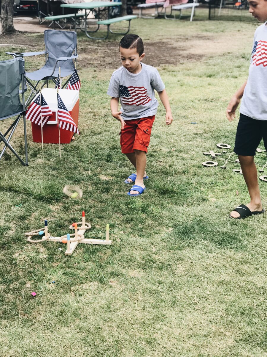 Kids play lawn games during 4th of July BBQ