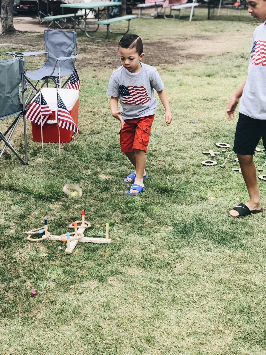 Kids play lawn games during 4th of July BBQ