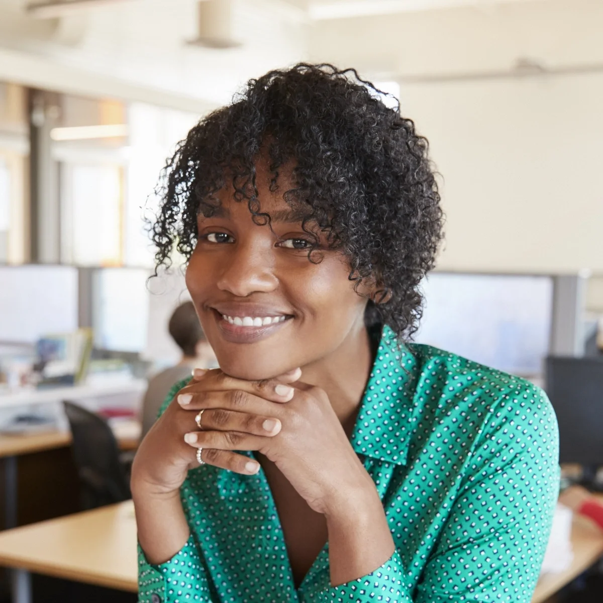 Content moderation representative smiling at desk