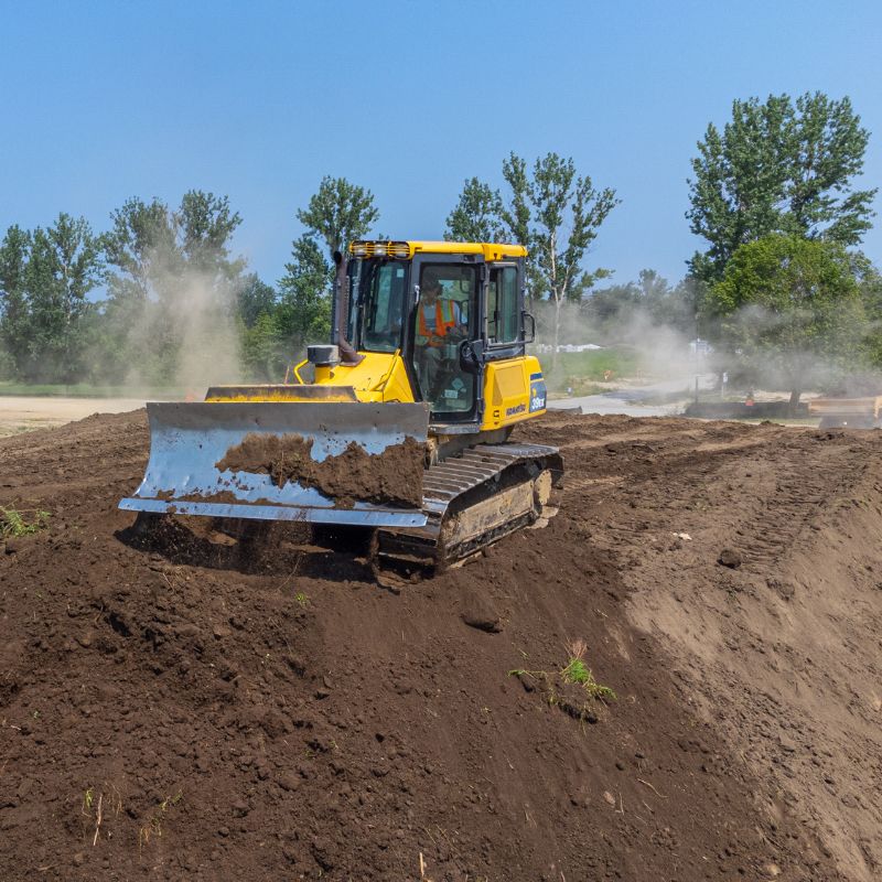 The Komatsu 39EX working on a construction site pushing dirt