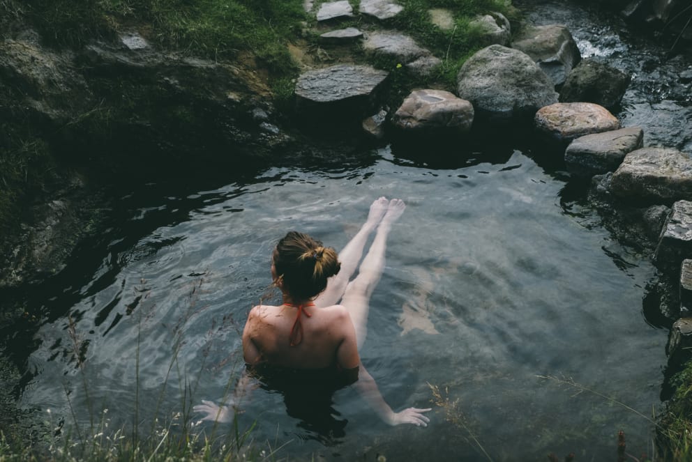 woman sitting in hot spring