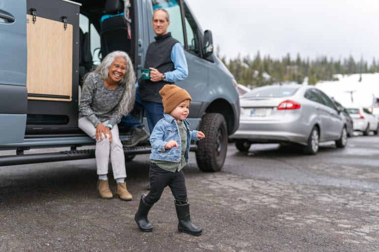 grandparents and grandson hanging outside of RV