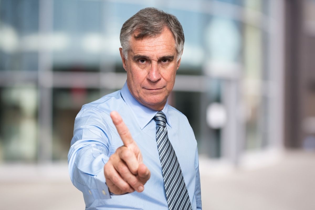 man waving finger "no" to enrolling in Medicare Advantage