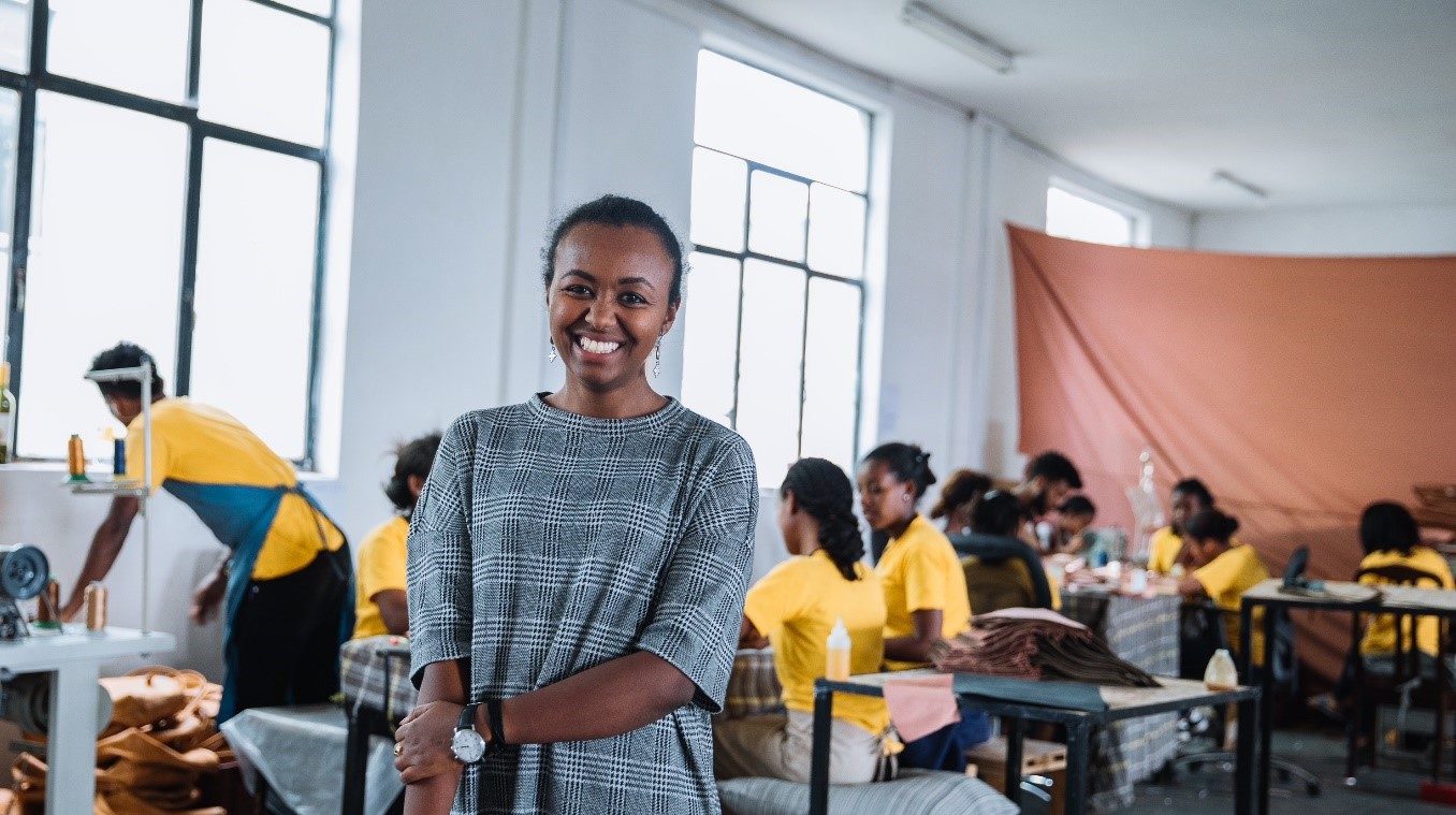 Woman stands smiling to camera 