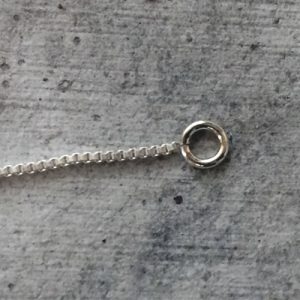 Lining up the silver jewelry chain and jump ring