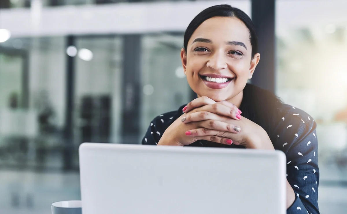 Finance representative smiling at desk