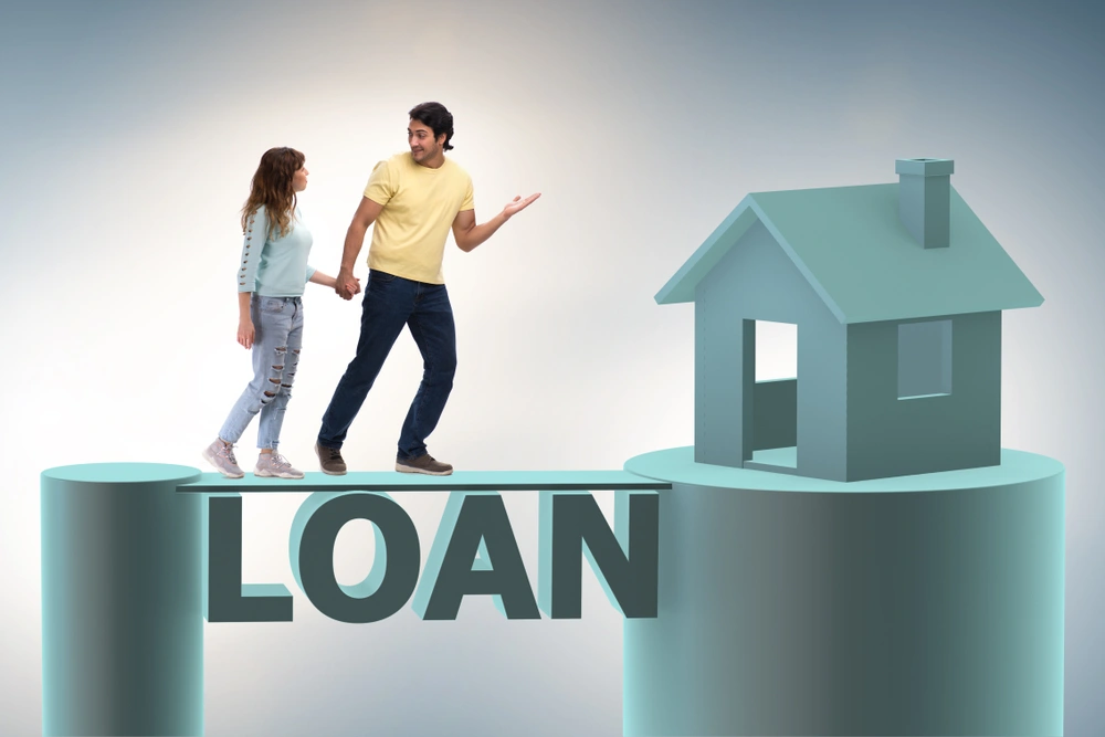 Couple standing on a CGI bridge written with the word loan which leads to a house.