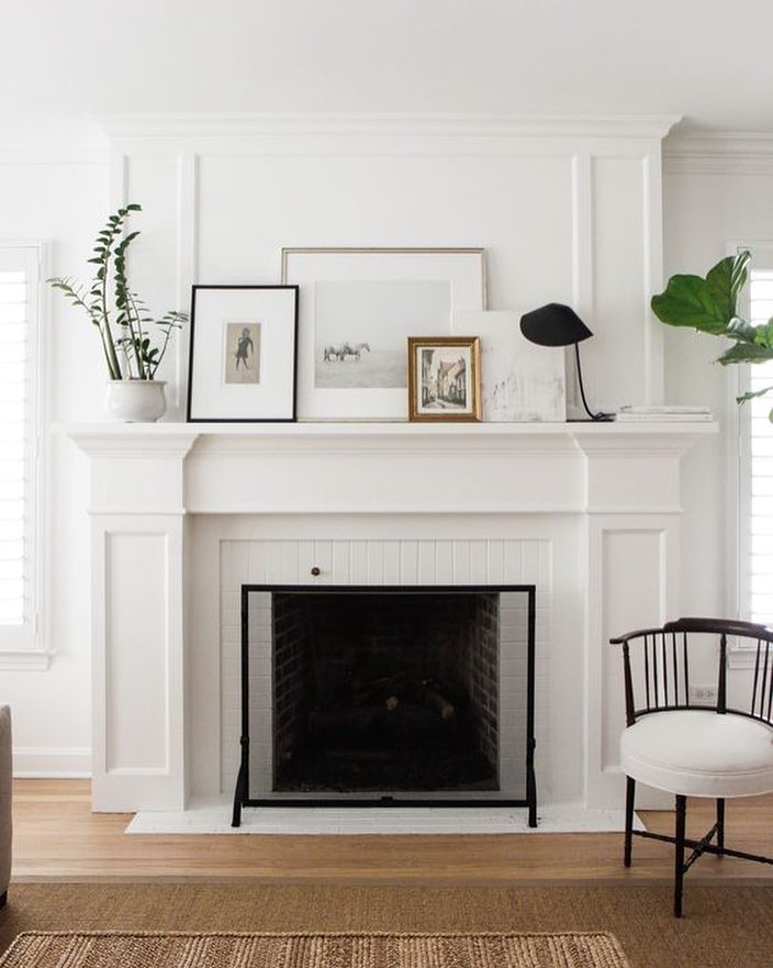 layered frames on white fireplace