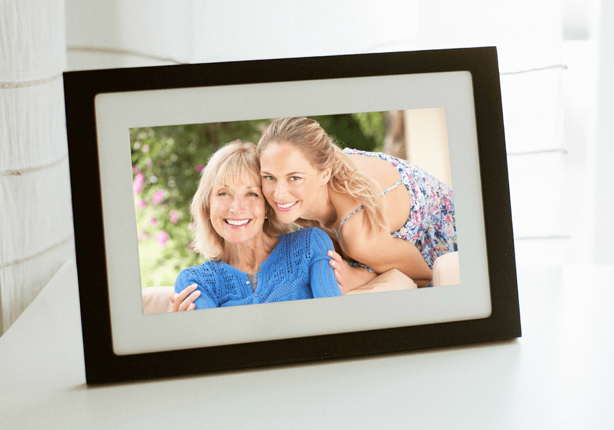Two women hugging displayed on digital photo frame