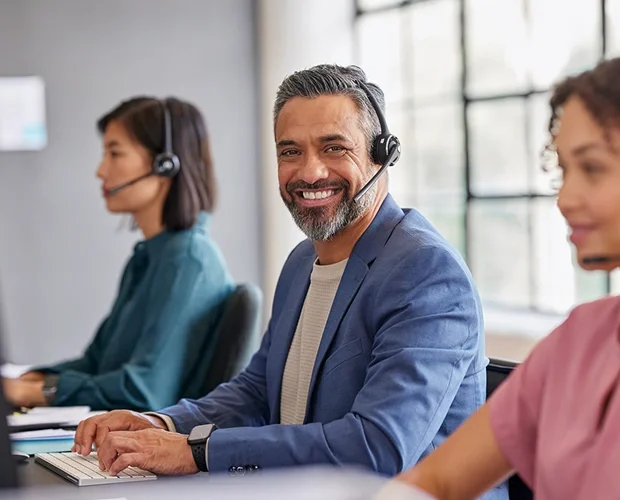 Customer service representative smiling at desk