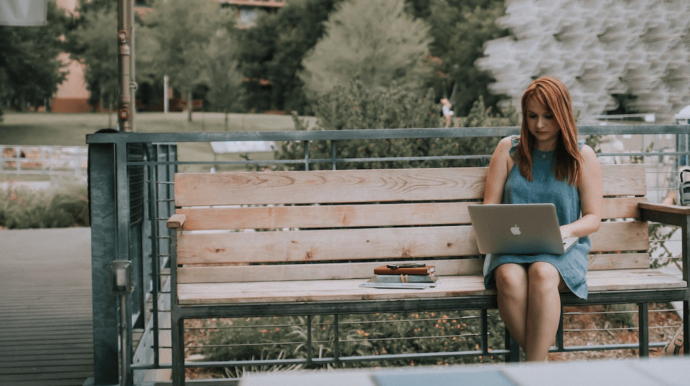 Woman working at laptop in park