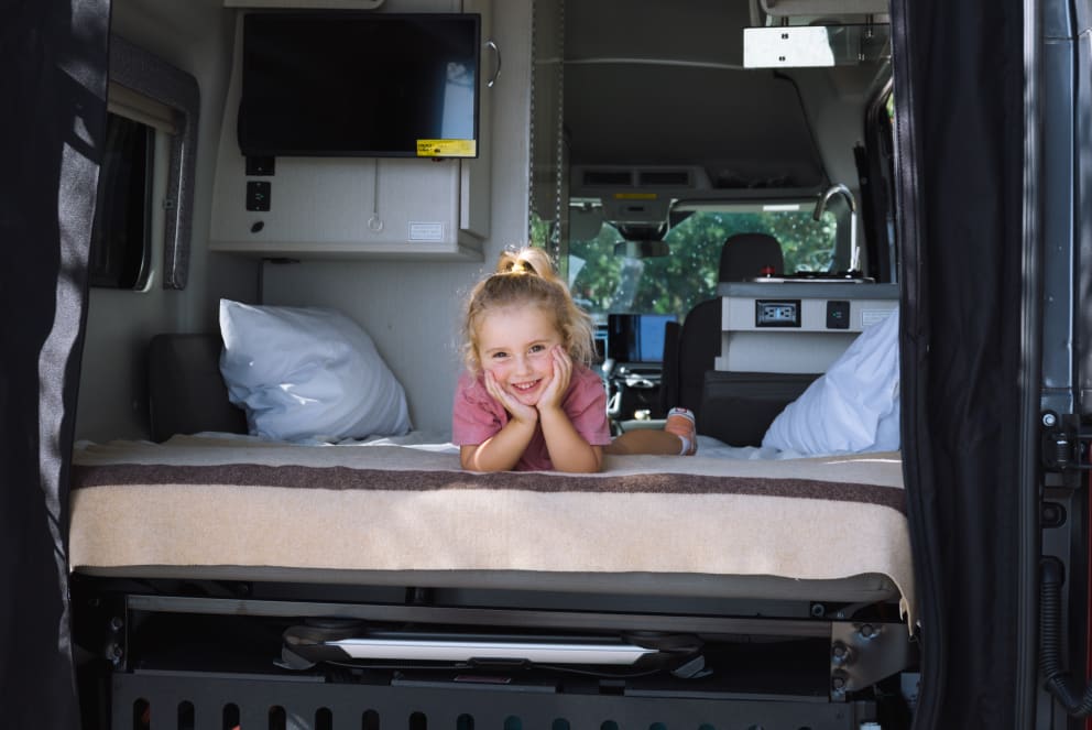 girl sitting inside class b rv