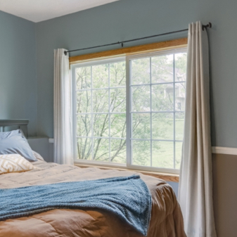 Bedroom with blue walls and Infinity fiberglass slider window