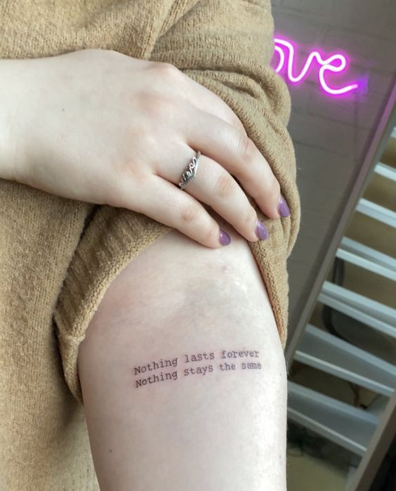 quote tattoo on woman's arm