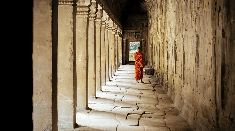 Buddhist monk in orange robe walking