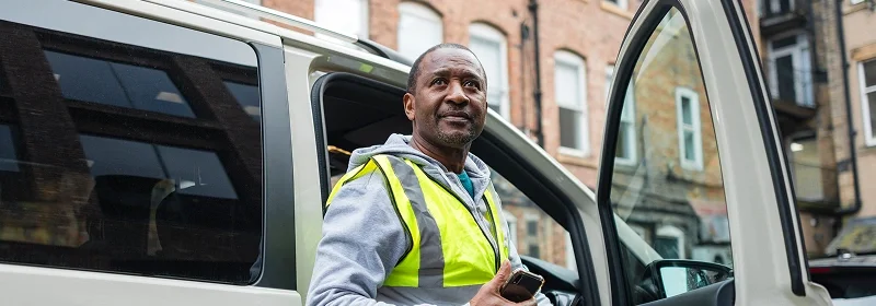 man-getting-out-of-a-van.webp