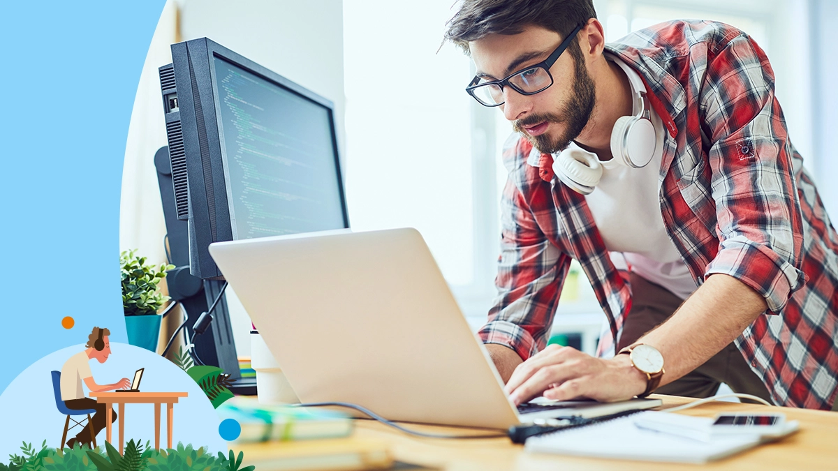 Man in checkered shit working on a laptop