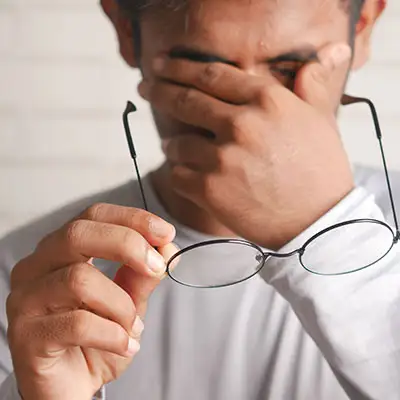 Man rubbing his tired eyes.