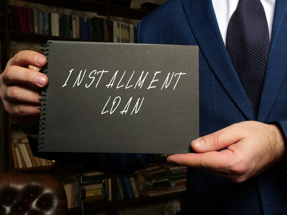 man holding installment loan book