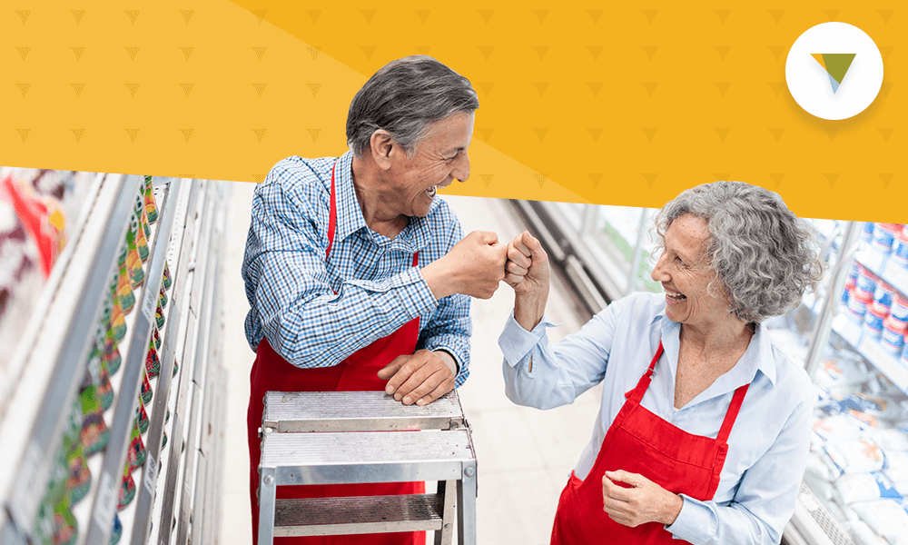 Elderly workers fist bumping