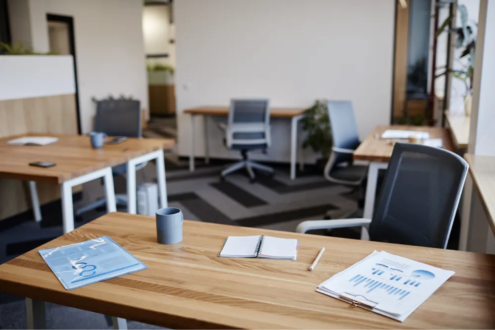 Organized office workspace with financial reports and performance dashboards