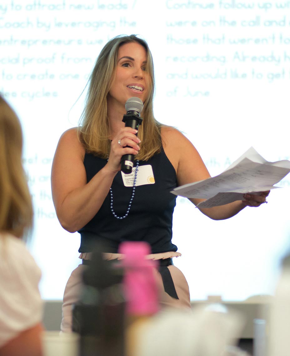 Rebecca Scoular at the front of a entrepreneur workshop, speaking to a group