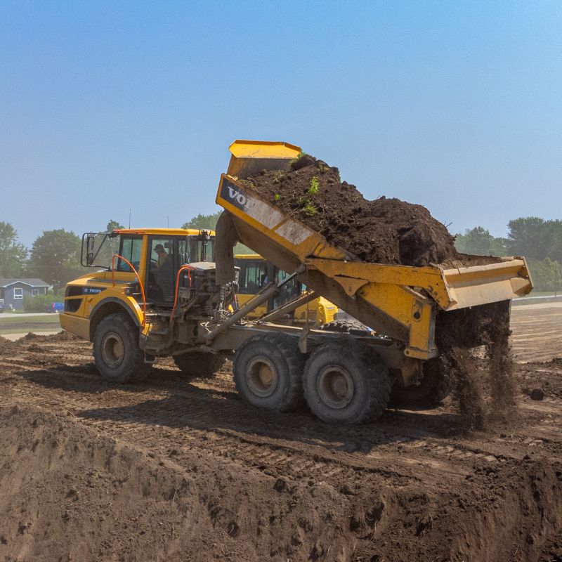 dump truck dumping dirt