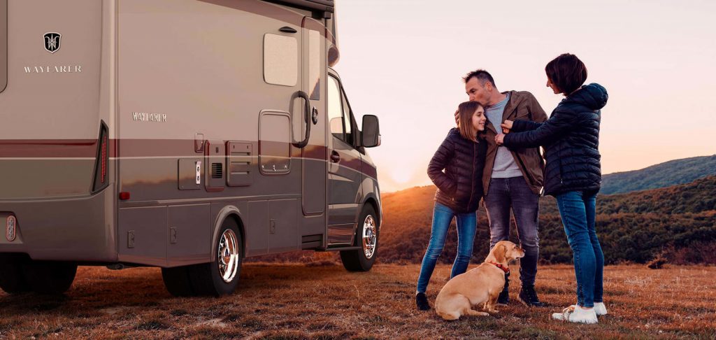 dad, daughter, mother and dog outside of RV at sunset