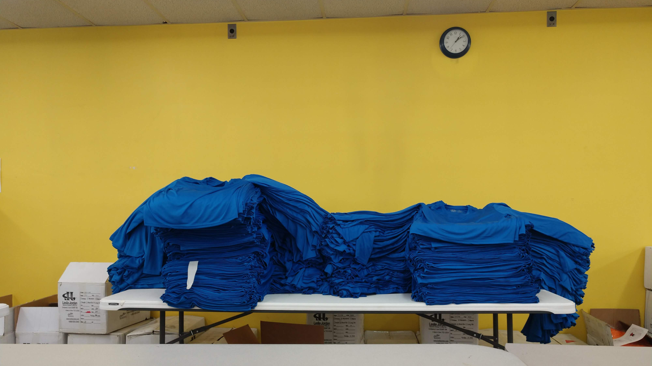 Several hundred t-shirts prepared for screen printing.