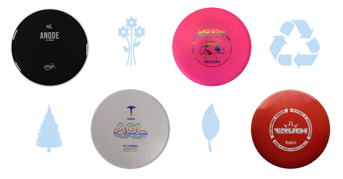disc golf discs with symbols of nature and the recycling symbol on white background
