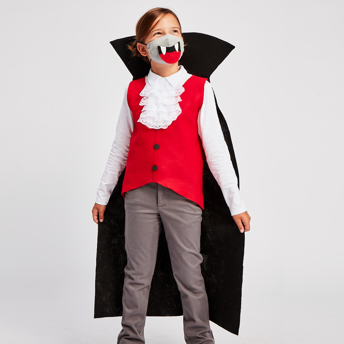 child wearing vampire costume with a face mask