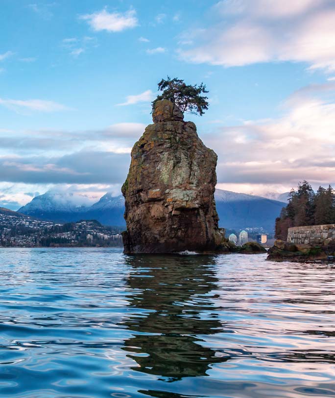 Siwash Rock, a prominent sea stack located off the Seawall in Stanley Park, Vancouver