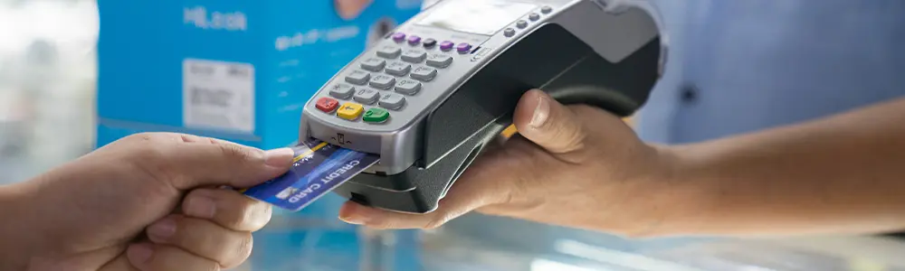 person entering credit card into machine