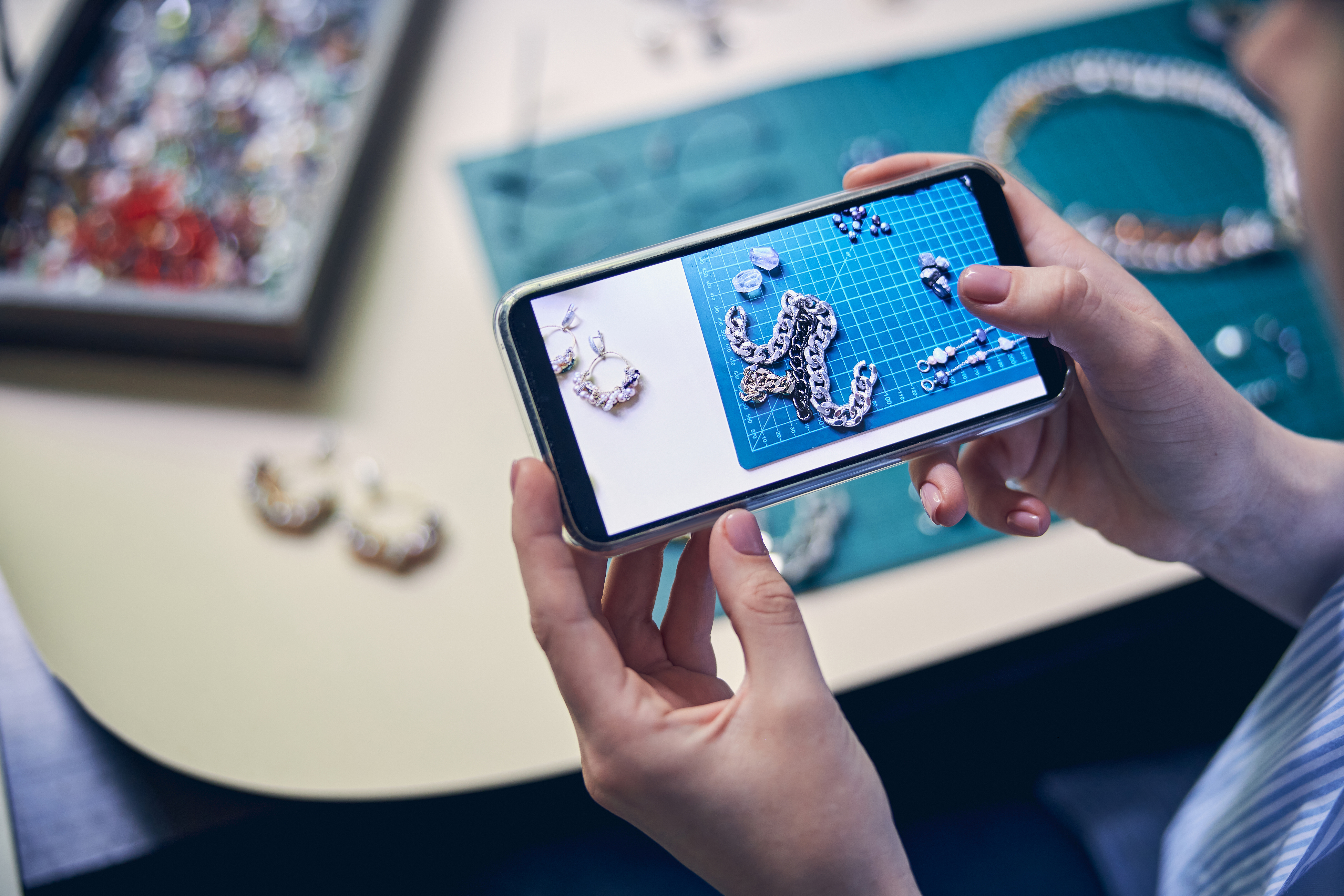 Woman taking a photo of her jewelry