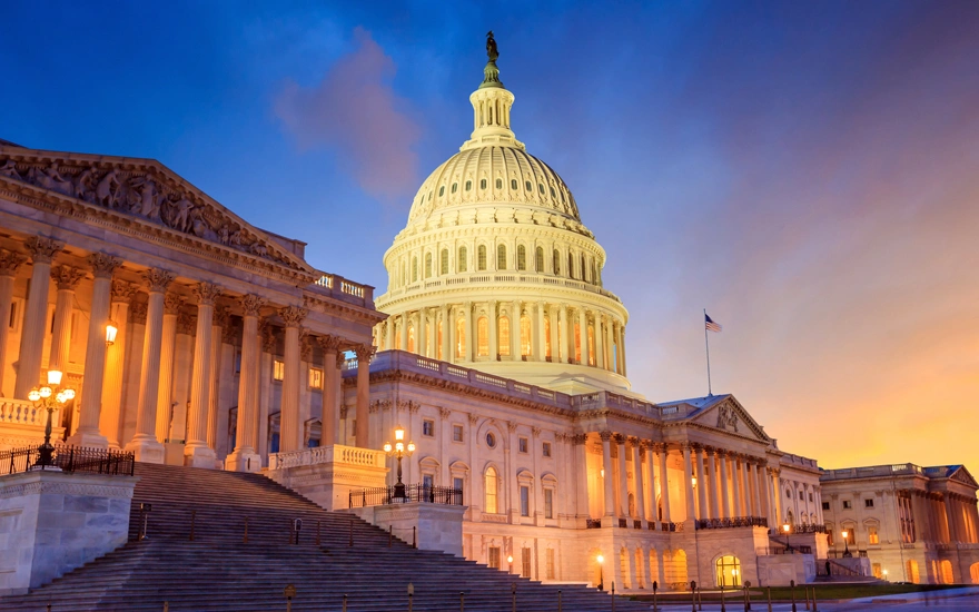 The United States Capitol building with the dome lit up at night