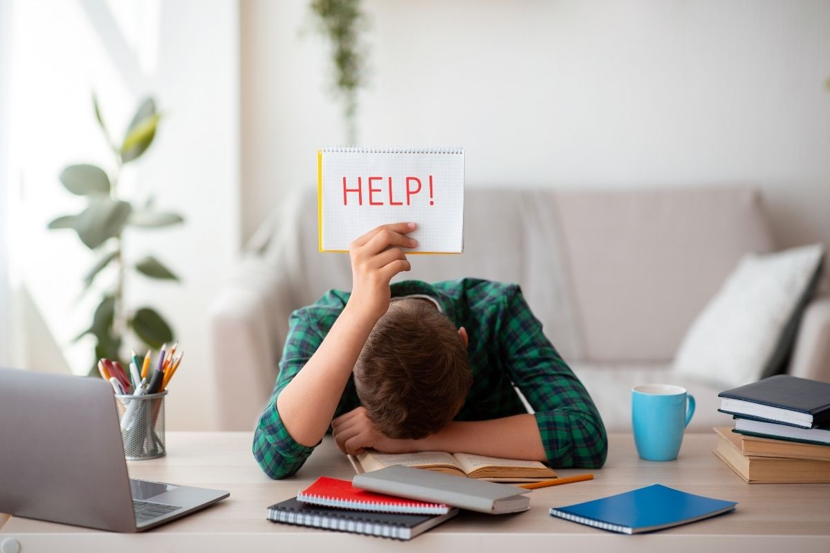 man with head down, holding up sign that says "help" with healthcare during retirement