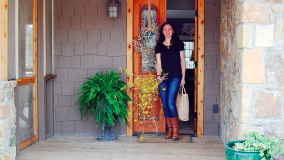 Woman standing next to home entrance