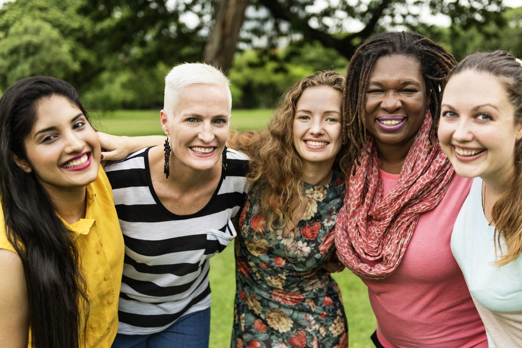 Image of a group of multicultural, multi-aged women in a huddle