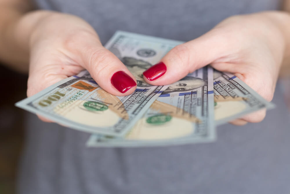 woman holding payday loan cash