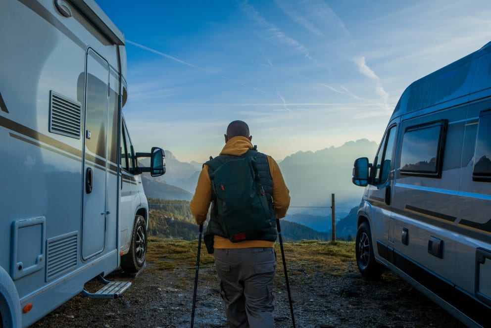 man hiking in the mountains camping in rv