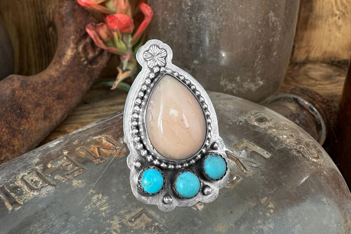 southwestern ring with pear shaped pink stone, turquoise, and embellishments