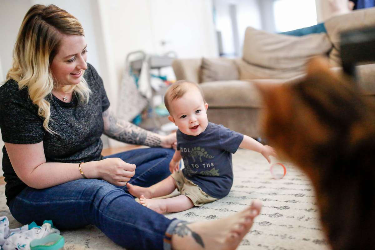 mother sitting on the floor with her baby