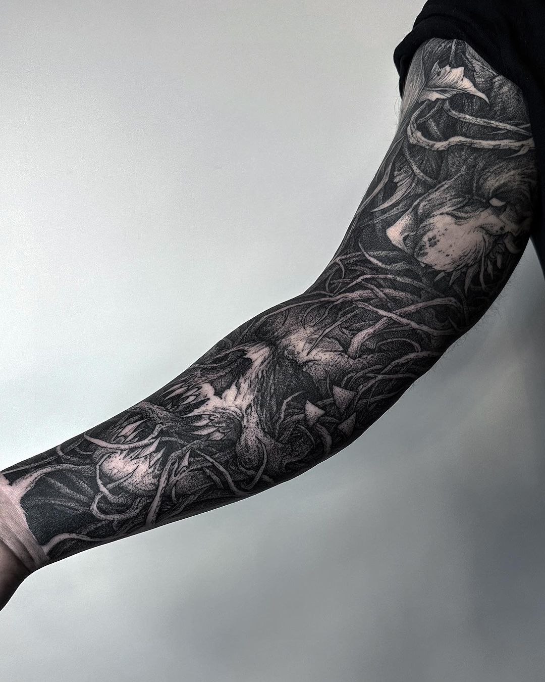 black and grey sleeve tattoo by kamil jedrzejczyk