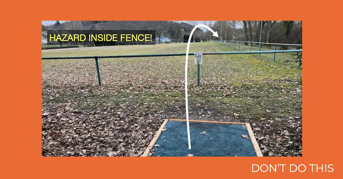 A photo of a disc golf hole with arrow showing line and basket position an notice about what area is hazard on an ornge background with a note saying "Don't do this"